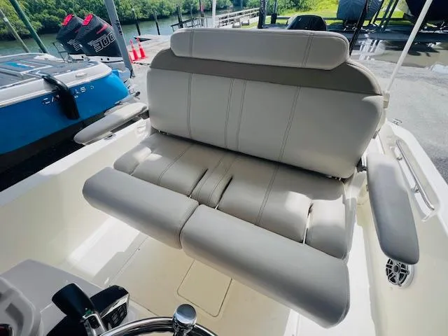 Slide: The Image of 2023 Boston Whaler 250 Dauntless boat interior with cushioned seating. - 16