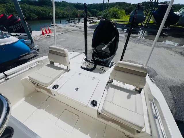 Slide: The Image of 2023 Boston Whaler 250 Dauntless boat interior with seating and Mercury engine. - 17