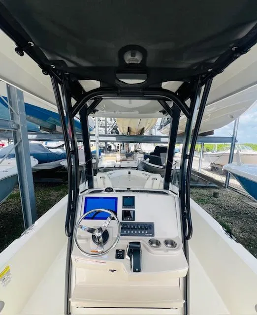 Slide: The Image of 2023 Boston Whaler 250 Dauntless boat interior with steering console and navigation equipment. - 25