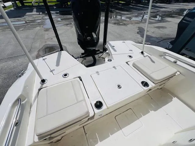 Slide: The Image of 2023 Boston Whaler 250 Dauntless boat interior with cushioned seating and storage compartments. - 27