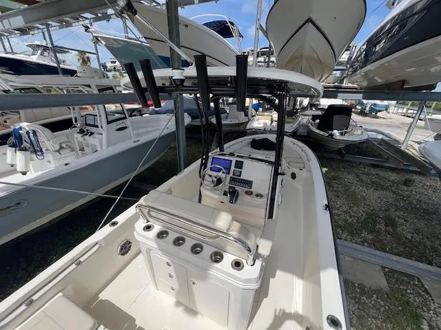 Slide: The Image of 2023 Boston Whaler 250 Dauntless boat in storage, featuring a sleek console and seating area. - 32
