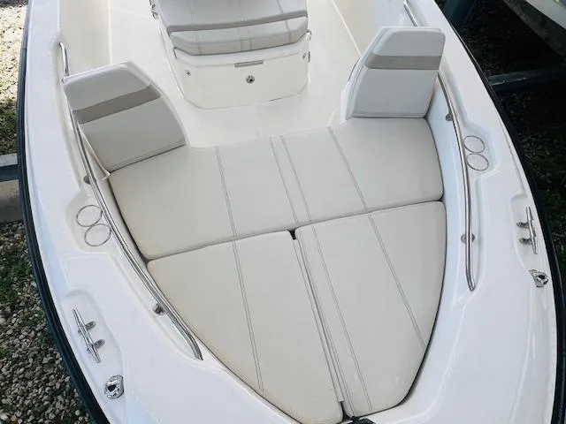 Slide: The Image of 2023 Boston Whaler 250 Dauntless boat interior with cushioned seating. - 6