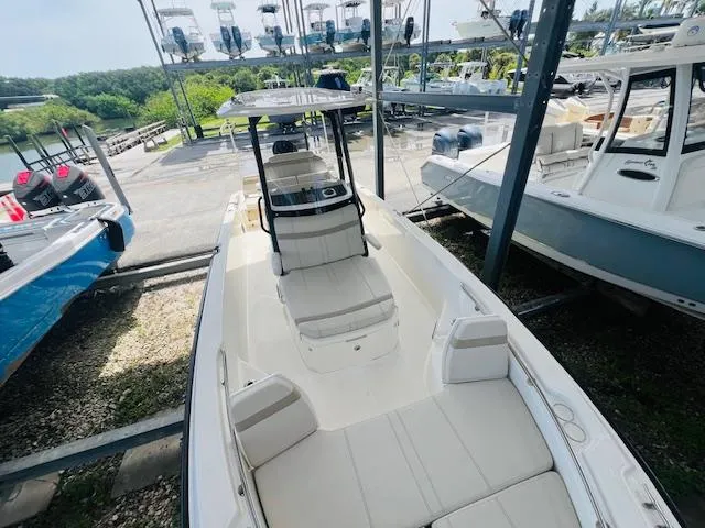 Slide: The Image of 2023 Boston Whaler 250 Dauntless boat in storage, showcasing sleek design and spacious seating. - 8