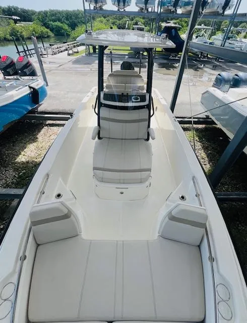 Slide: The Image of 2023 Boston Whaler 250 Dauntless boat, sleek design, spacious seating, docked outdoors. - 9