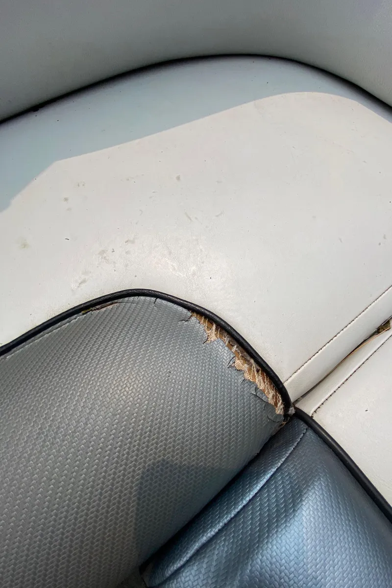 Slide: The Image of 2011 Moomba Mobius LSV boat seat with visible wear and tear. - 12