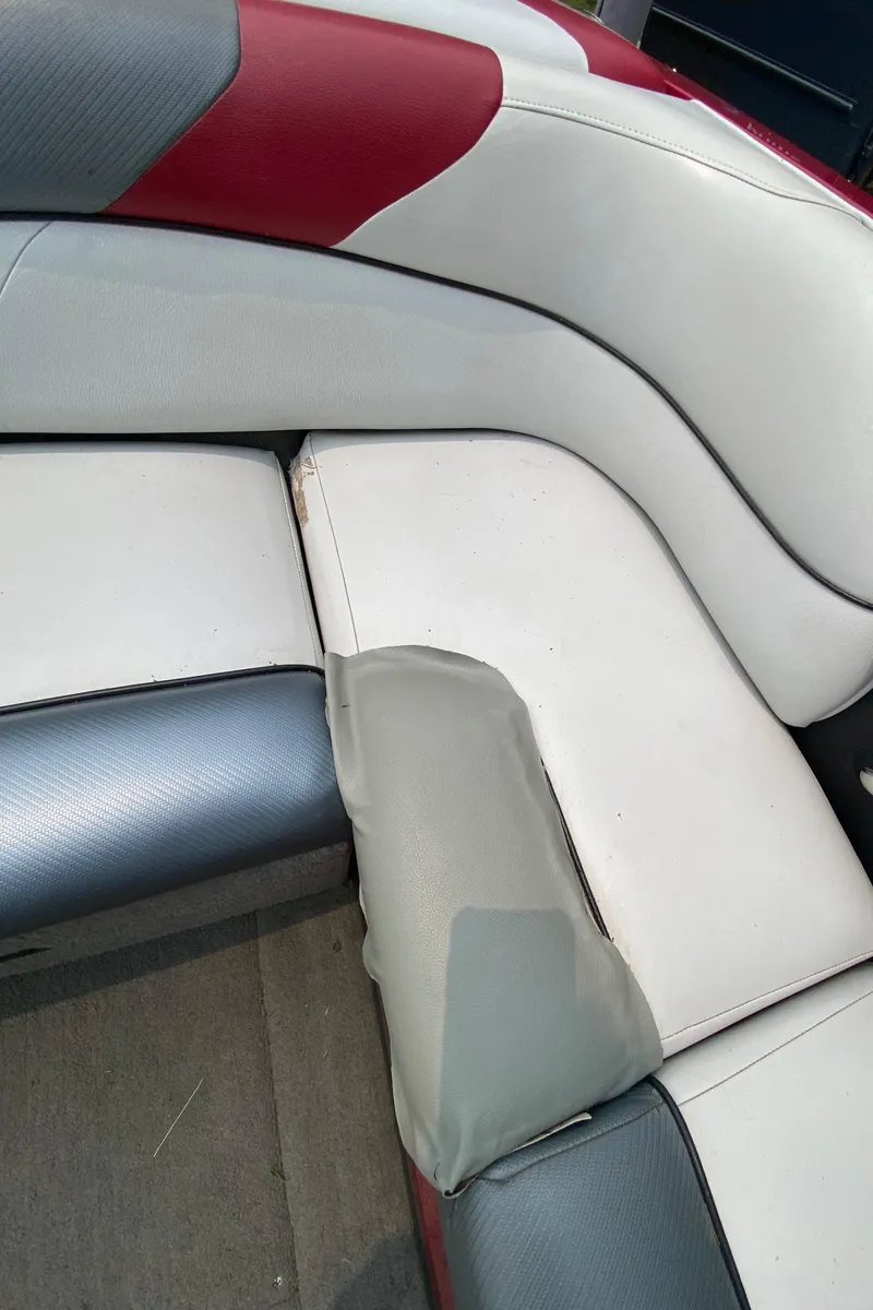Slide: The Image of 2011 Moomba Mobius LSV boat interior with red, white, and gray seating. - 14