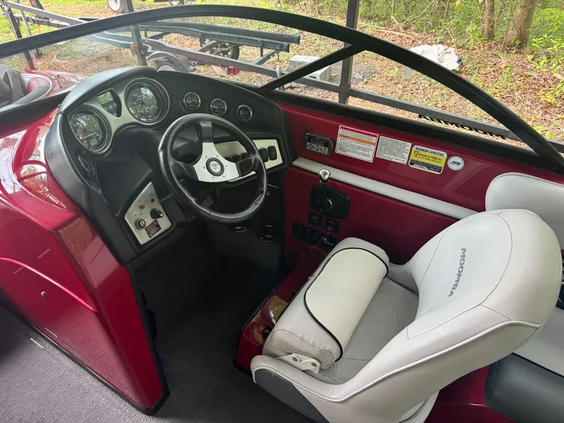 Slide: The Image of 2011 Moomba Mobius LSV boat interior with steering wheel and dashboard controls. - 4