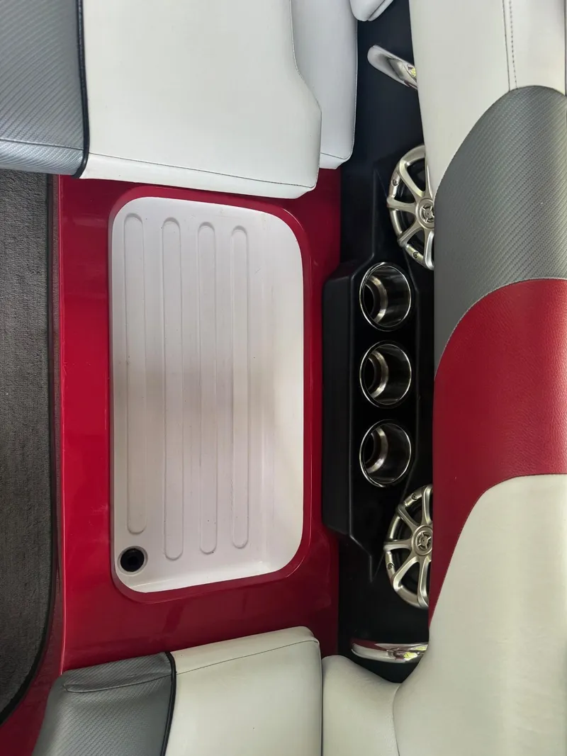 Slide: The Image of 2011 Moomba Mobius LSV interior with red, white, and gray seating and cup holders. - 5