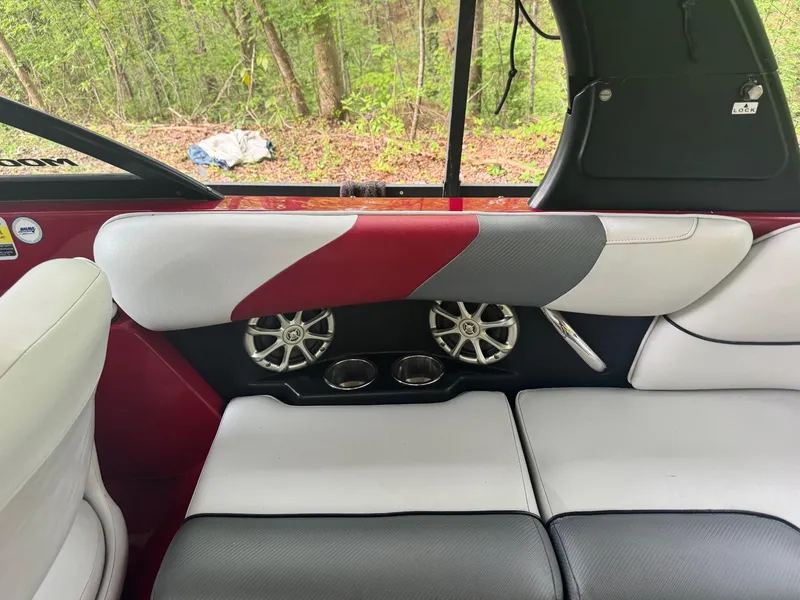 Slide: The Image of 2011 Moomba Mobius LSV boat interior with red, gray, and white seating and built-in speakers. - 6