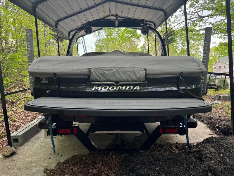 Slide: The Image of 2011 Moomba Mobius LSV boat covered and parked under a shelter. - 9