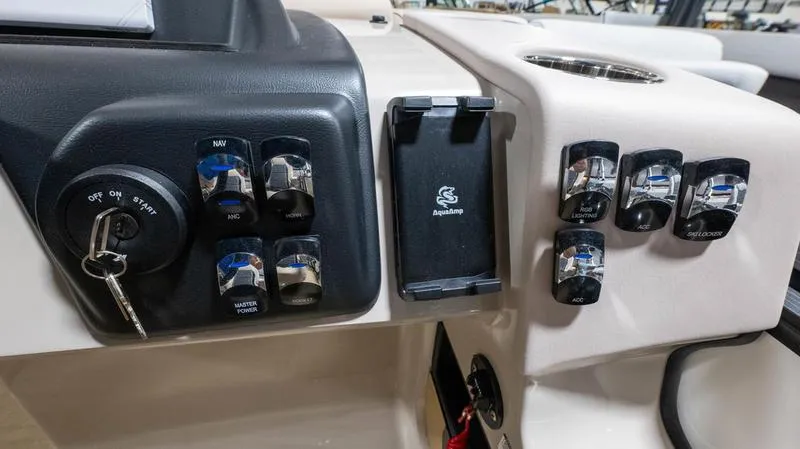 Slide: The Image of Dashboard of 2025 Harris Cruiser 230 SLDH with switches and ignition key. - 14