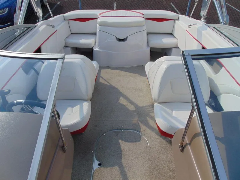 Slide: The Image of 2009 Four Winns H210 boat interior with white and red seating, open bow design. - 12