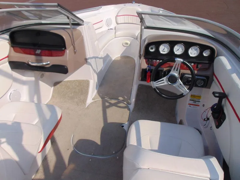 Slide: The Image of Interior of 2009 Four Winns H210 boat with steering wheel and dashboard. - 8