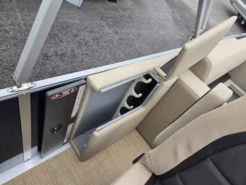 Slide: The Image of 2025 Harris Cruiser 210 FC boat interior with beige seating and built-in cup holders. - 10