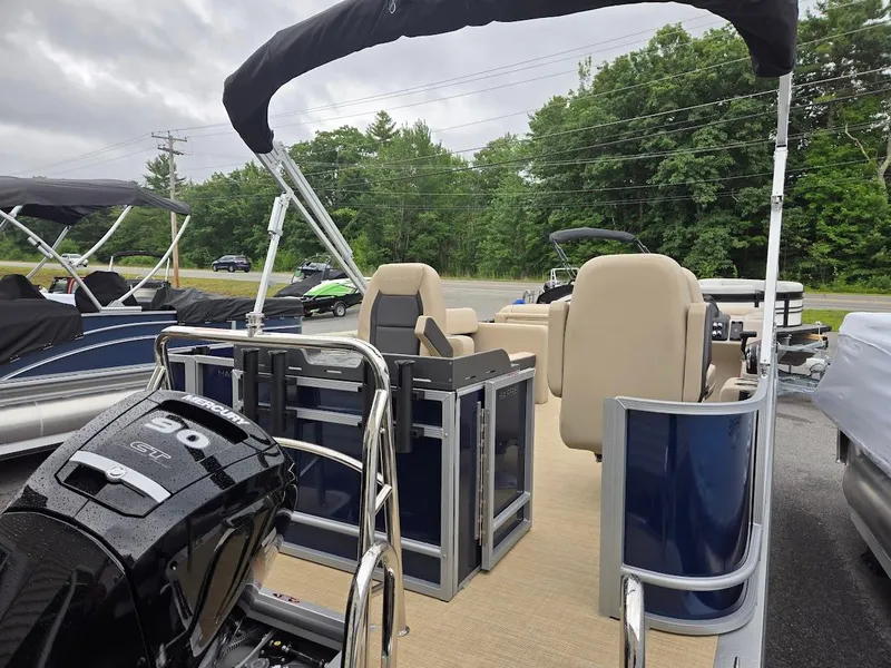 Slide: The Image of 2025 Harris Cruiser 210 FC pontoon boat with outboard motor, docked outdoors. - 3