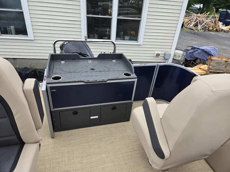 Slide: The Image of 2025 Harris Cruiser 210 FC boat interior with seating and storage compartments. - 4