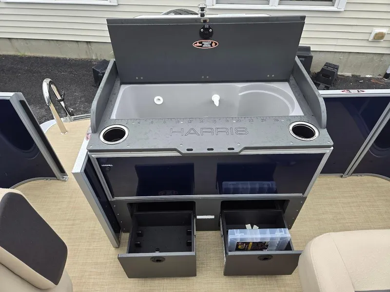 Slide: The Image of Harris Cruiser 210 FC 2025 boat interior with storage compartments and sink. - 5