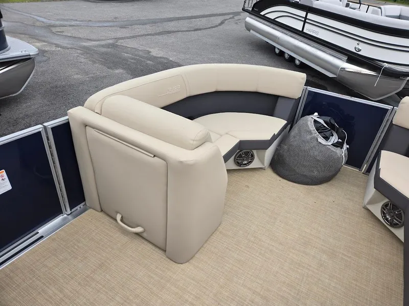 Slide: The Image of 2025 Harris Cruiser 210 FC boat interior with beige seating and carpet flooring. - 7