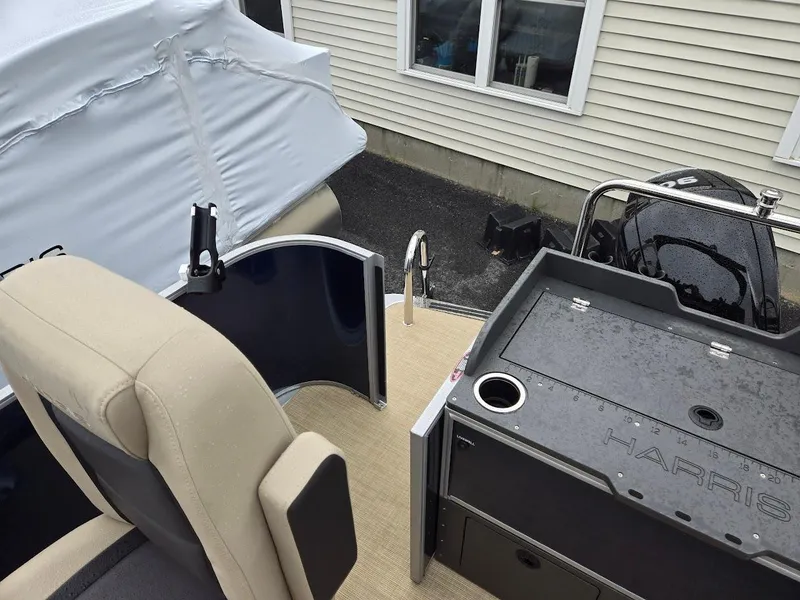 Slide: The Image of 2025 Harris Cruiser 210 FC boat interior with seating and console. - 9