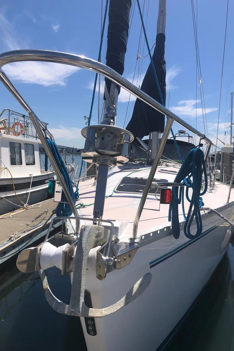 Slide: The Image of 1997 Catalina 400 sailboat docked at marina under clear blue sky. - 12