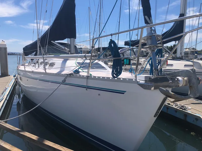 Slide: The Image of 1997 Catalina 400 sailboat docked at marina under clear blue sky. - 14