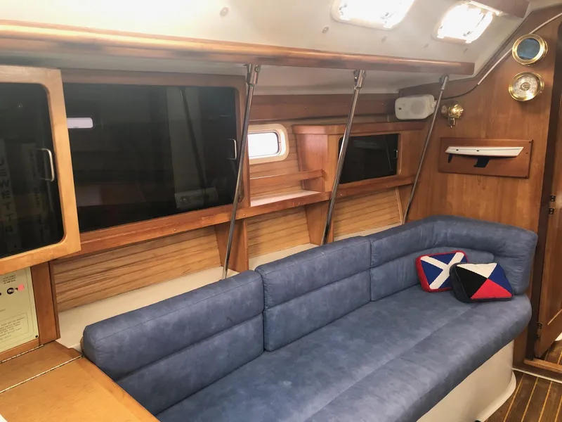 Slide: The Image of Interior of 1997 Catalina 400 sailboat with blue seating and wooden accents. - 2
