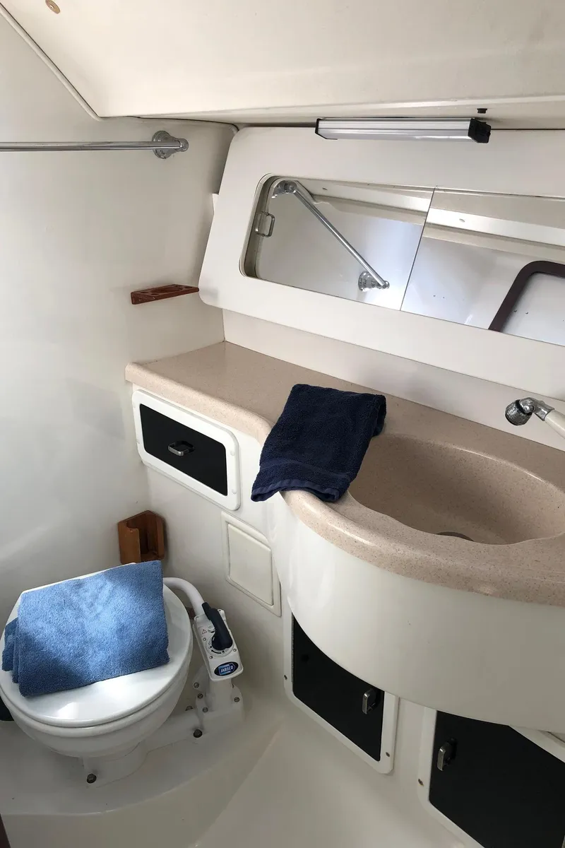 Slide: The Image of 1997 Catalina 400 yacht bathroom with sink, mirror, and toilet. - 8