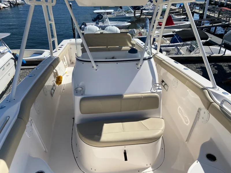 Slide: The Image of 2016 Pursuit S 280 Sport boat interior with seating and helm, docked at marina. - 10