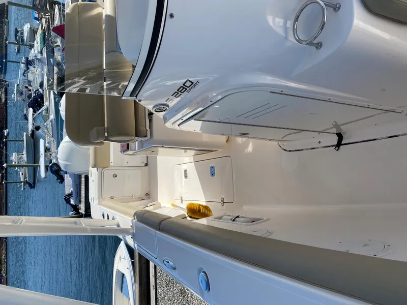 Slide: The Image of 2016 Pursuit S 280 Sport boat docked at marina, showcasing sleek interior design. - 12