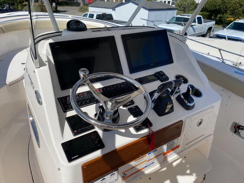 Slide: The Image of 2016 Pursuit S 280 Sport boat dashboard with dual screens and steering wheel. - 15