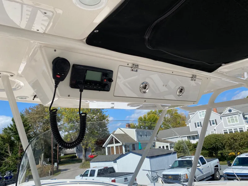 Slide: The Image of 2016 Pursuit S 280 Sport boat interior with radio and storage compartment. - 16