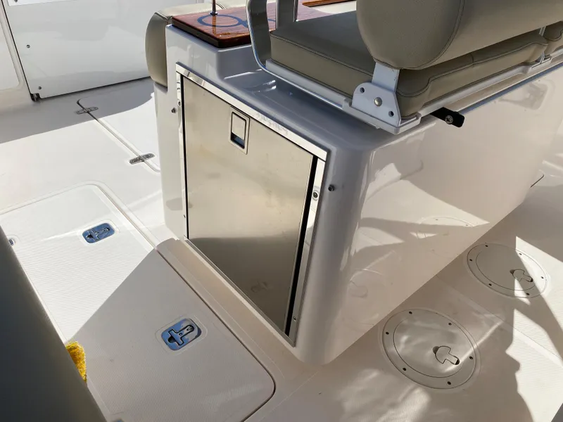 Slide: The Image of 2016 Pursuit S 280 Sport boat interior with seating and storage compartment. - 19