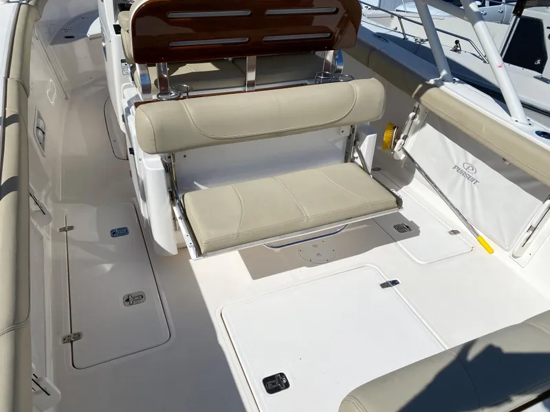 Slide: The Image of 2016 Pursuit S 280 Sport boat interior with beige seating and white deck. - 23
