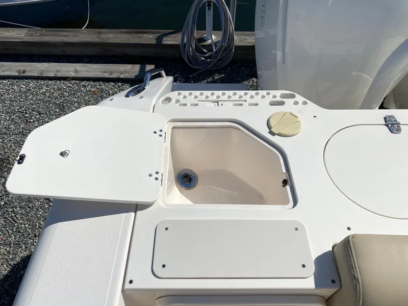 Slide: The Image of 2016 Pursuit S 280 Sport boat deck with open storage compartment. - 28