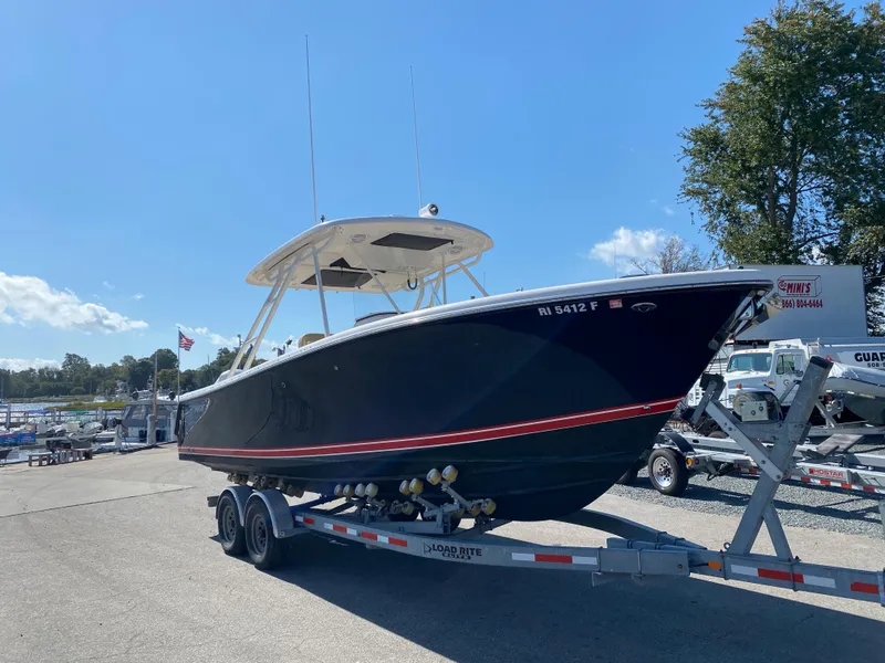 Slide: The Image of 2016 Pursuit S 280 Sport boat on trailer in sunny marina. - 3