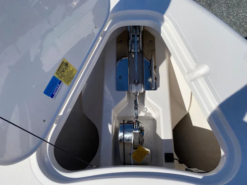 Slide: The Image of Anchor compartment of 2016 Pursuit S 280 Sport boat, showcasing chain and winch system. - 6
