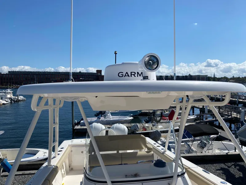 Slide: The Image of 2016 Pursuit S 280 Sport boat with Garmin radar, docked at marina under clear sky. - 7