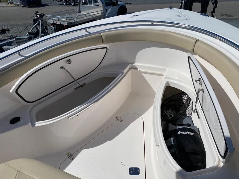 Slide: The Image of 2016 Pursuit S 280 Sport boat interior with storage compartments and seating. - 9
