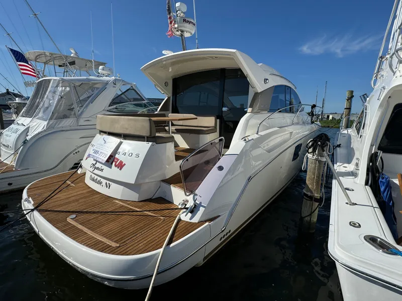 Slide: The Image of 2012 Prestige 440 S yacht docked at marina, featuring sleek design and spacious deck. - 14