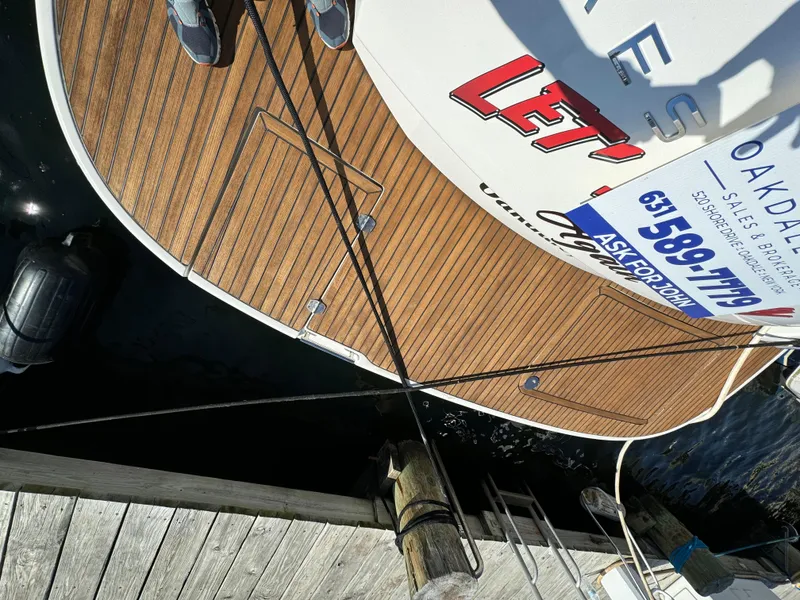 Slide: The Image of Prestige 440 S yacht docked, featuring teak deck and visible mooring lines, 2012 model. - 15
