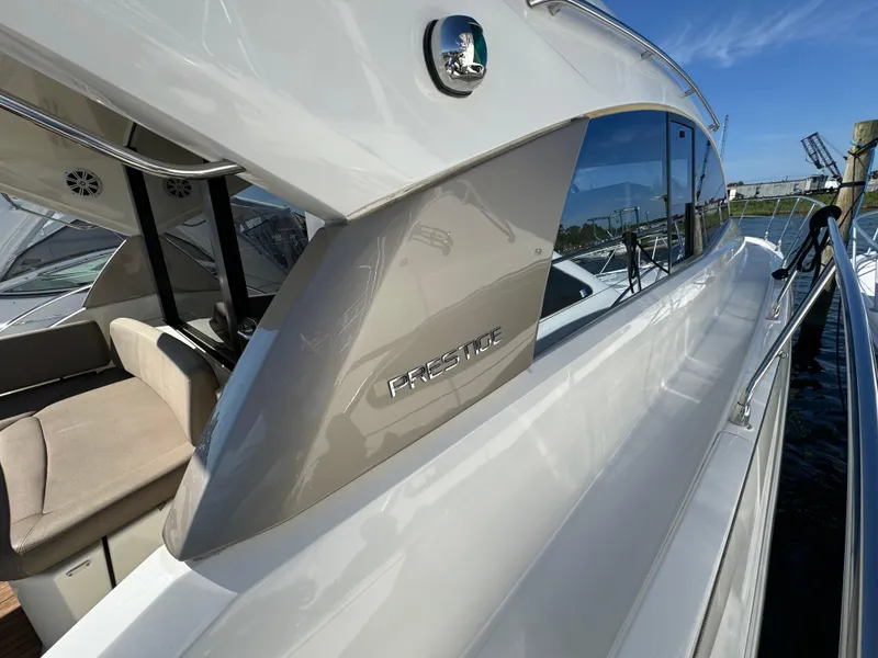 Slide: The Image of Prestige 440 S yacht, 2012 model, sleek design, docked under clear blue sky. - 19