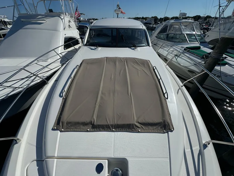 Slide: The Image of 2012 Prestige 440 S yacht with sunpad, docked among other boats. - 21