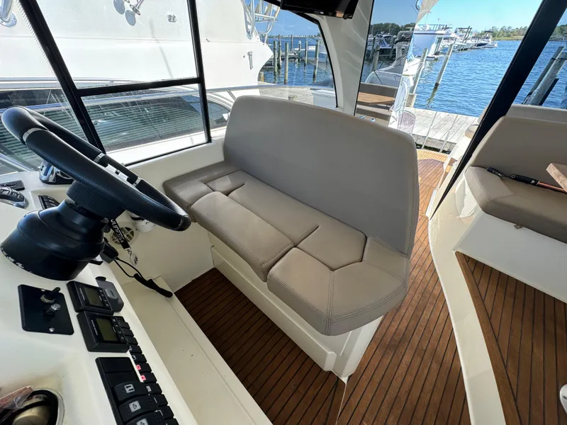 Slide: The Image of Interior of 2012 Prestige 440 S yacht with helm seat and wooden flooring. - 23