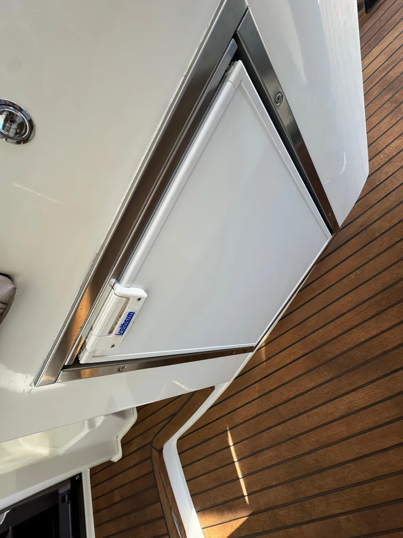 Slide: The Image of Prestige 440 S 2012 yacht with sleek white exterior and wooden deck. - 26
