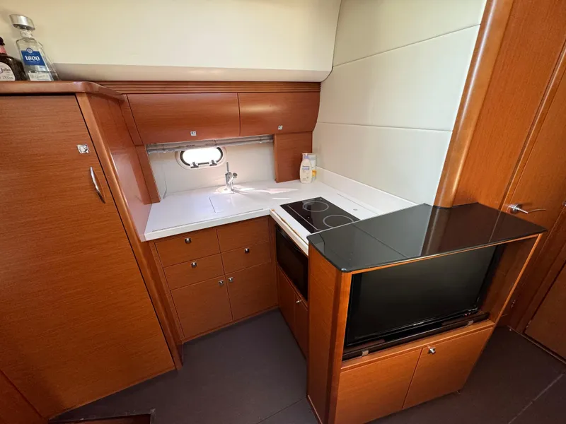 Slide: The Image of Compact kitchen in 2012 Prestige 440 S yacht with modern appliances and wood cabinetry. - 29