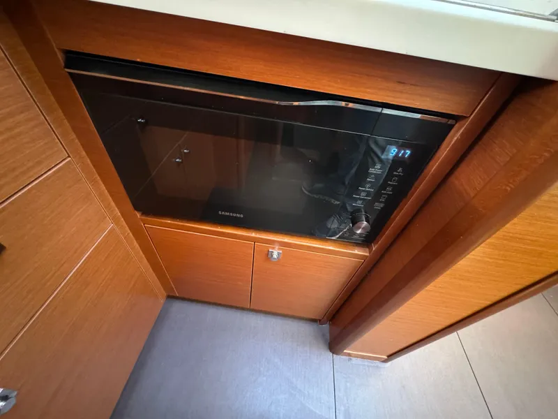 Slide: The Image of Microwave in 2012 Prestige 440 S yacht kitchen with wooden cabinetry. - 31