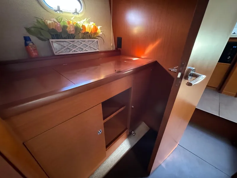 Slide: The Image of Interior of 2012 Prestige 440 S yacht with wooden cabinetry and floral decor. - 35