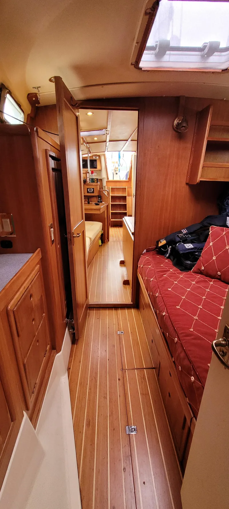 Slide: The Image of Interior of 1997 Saga 43 sailboat with wooden furnishings and cozy seating area. - 10