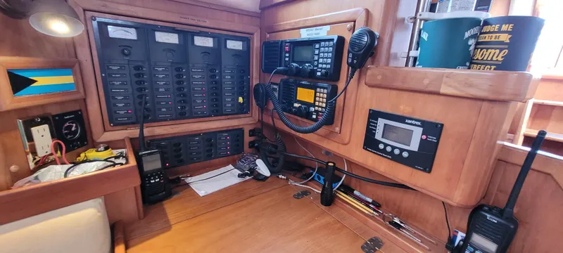 Slide: The Image of Navigation station on a 1997 Saga 43 sailboat with communication equipment and control panels. - 15