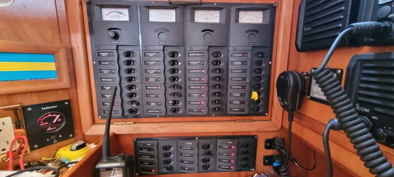 Slide: The Image of Electrical control panel on a 1997 Saga 43 boat, featuring switches and meters. - 17